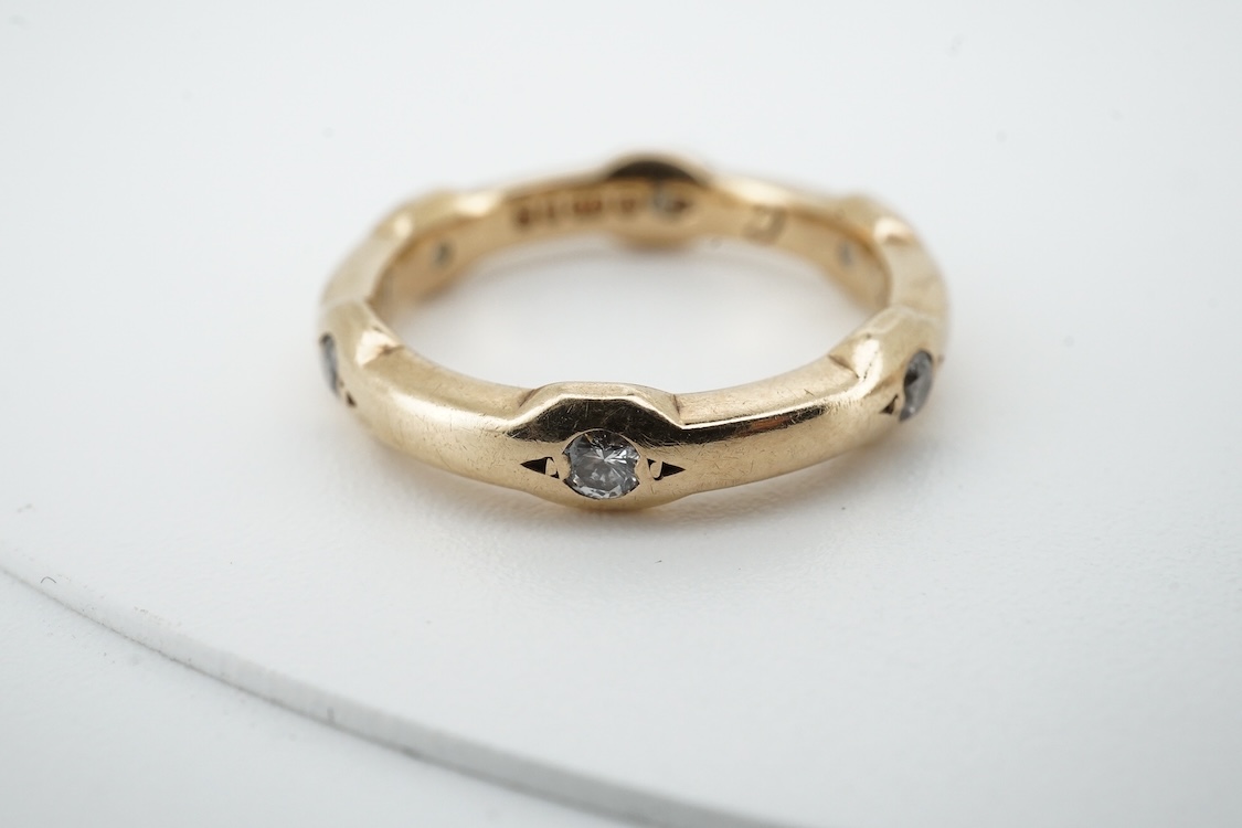 A modern 9ct gold and claw set single stone diamond ring, with four stone diamond chip set shoulders, size N, total carat weight approximately 0.20ct and a similar 9ct gold and six stone diamond set band, size K, gross w
